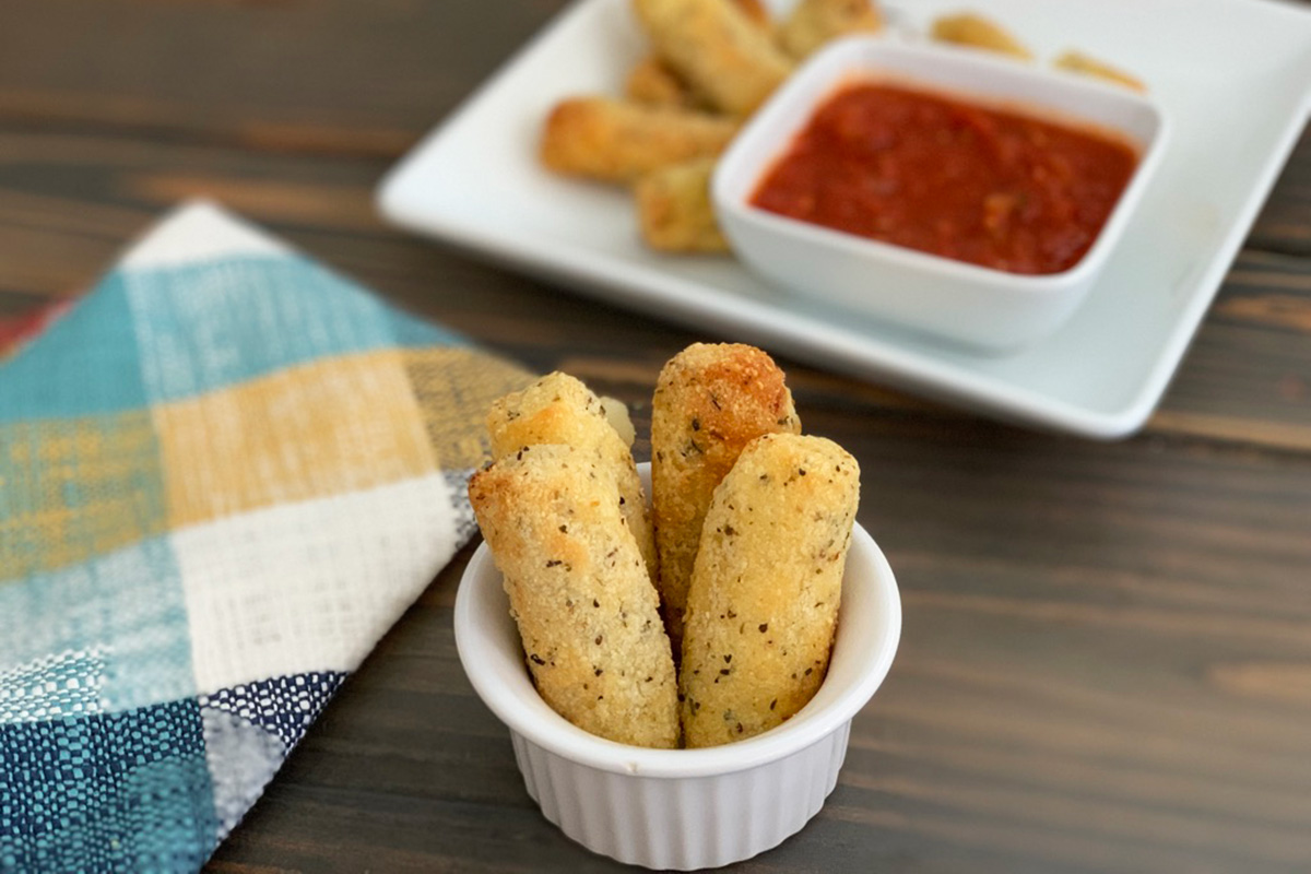 A serving of keto fried mozzarella sticks in a small dish