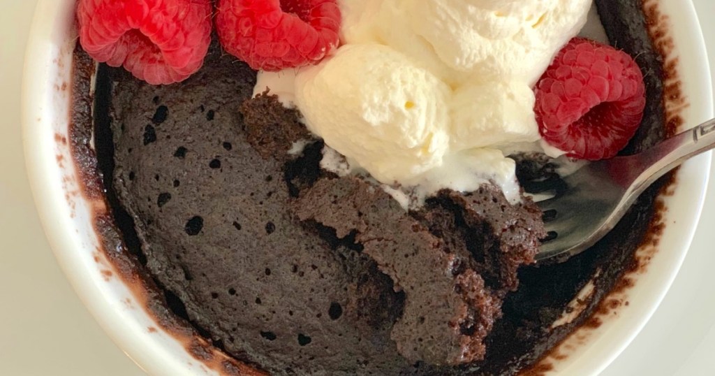 keto chocolate mug cake with whipped cream and berries