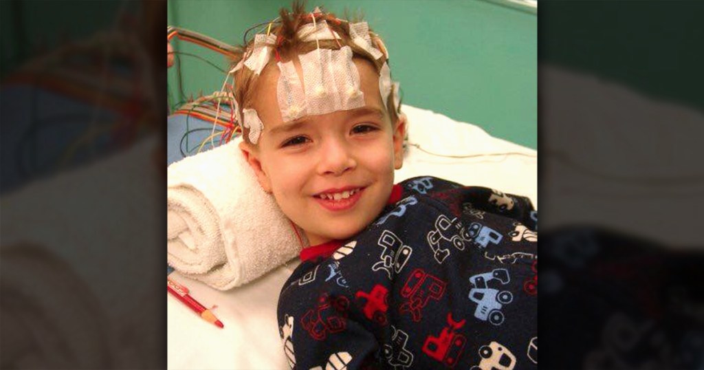 young boy smiling in hospital