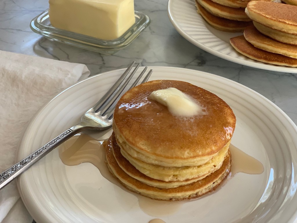keep pancakes with butter stacked on plate 