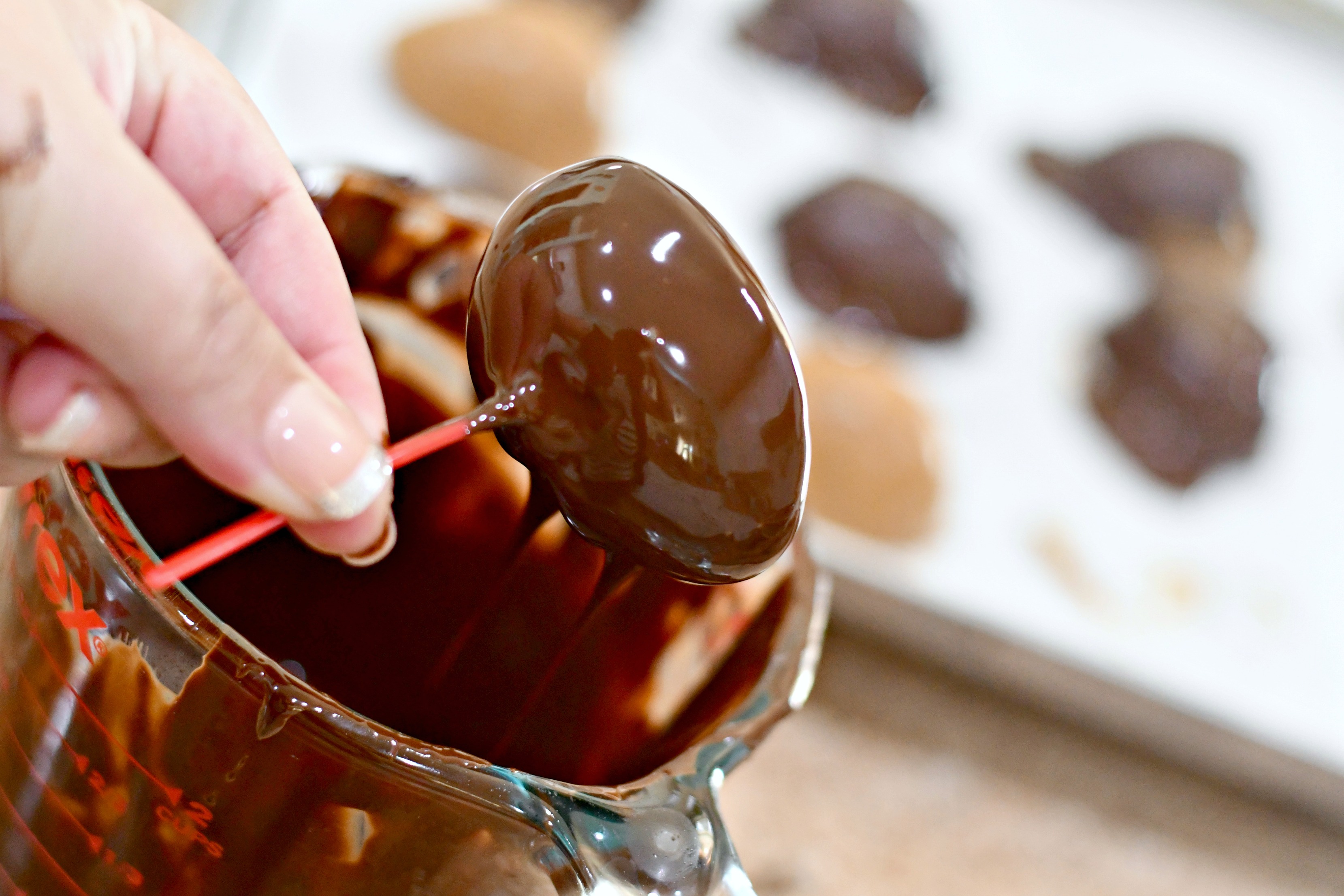 dipping keto almond butter eggs in chocolate