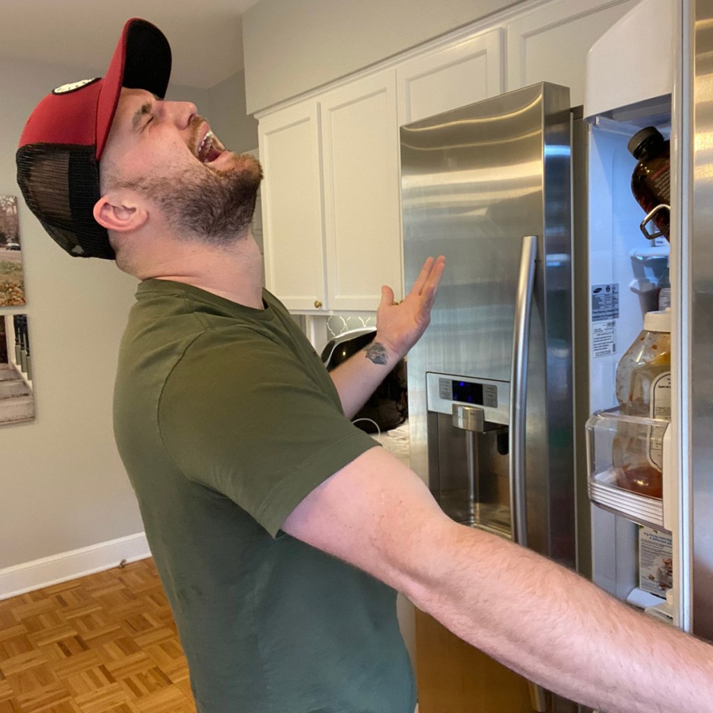 man in front of fridge