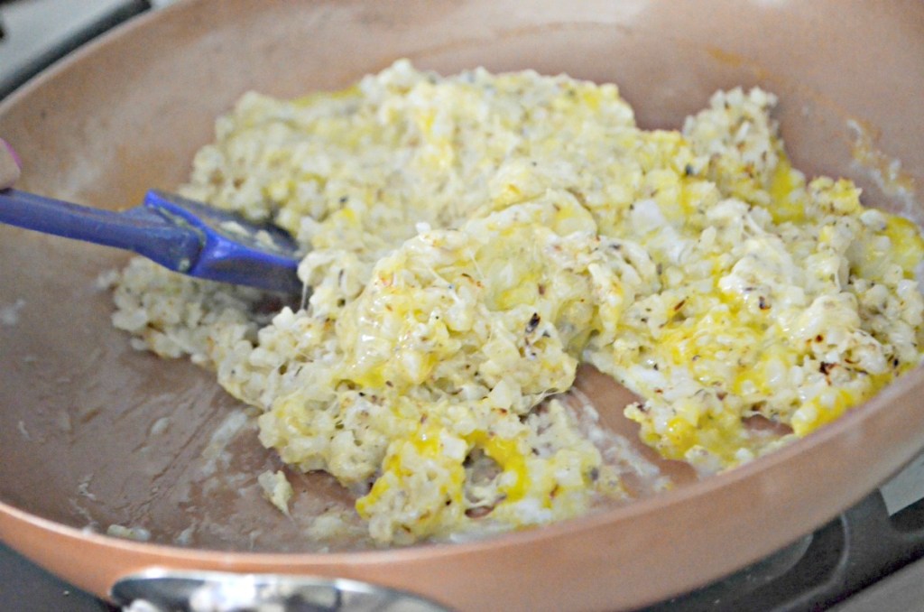 melting a cauliflower crust on a skillet 