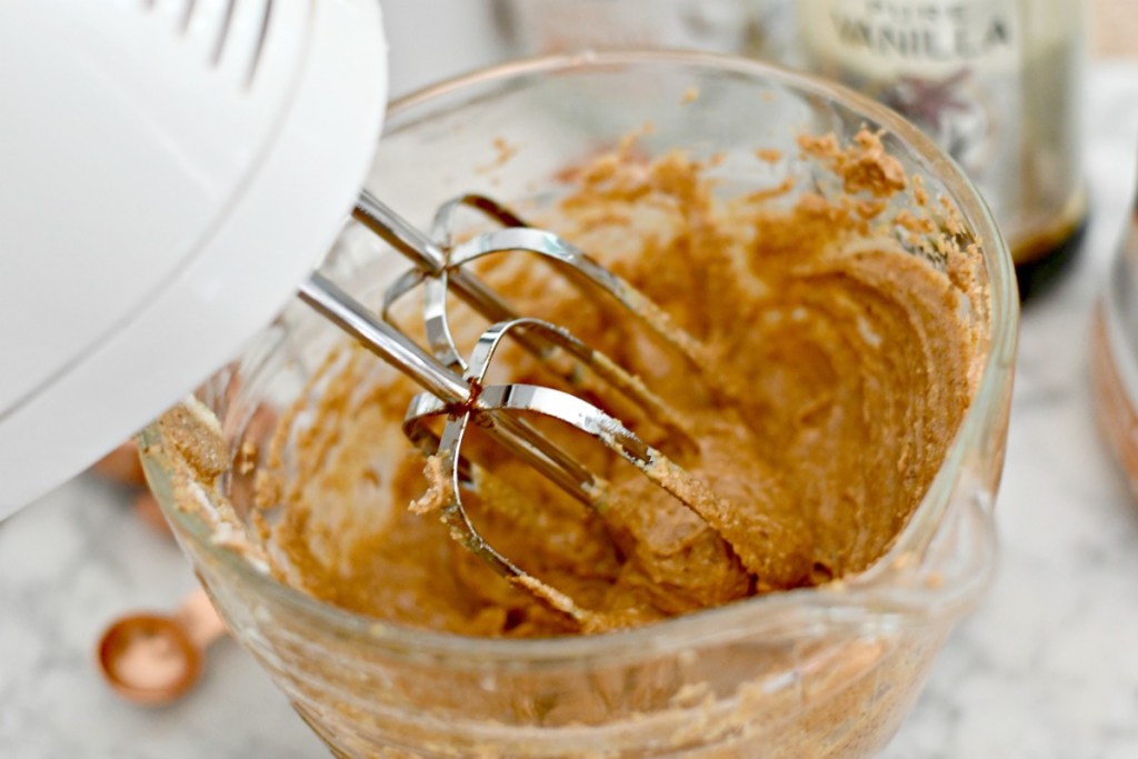 using a hand mixer to blend peanut butter filling