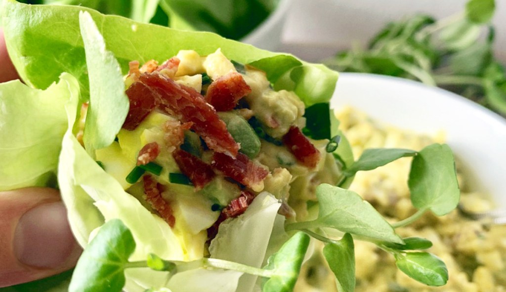 bacon avocado egg salad wrapped in lettuce with watercress