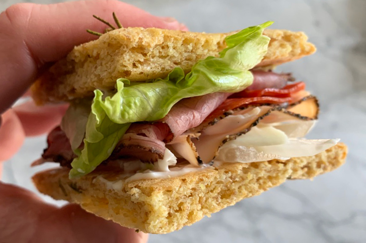 a sandwich made with keto rosemary focaccia bread