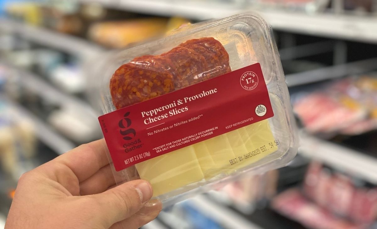 A hand holding a container of pepperoni and cheese slices keto food at Target