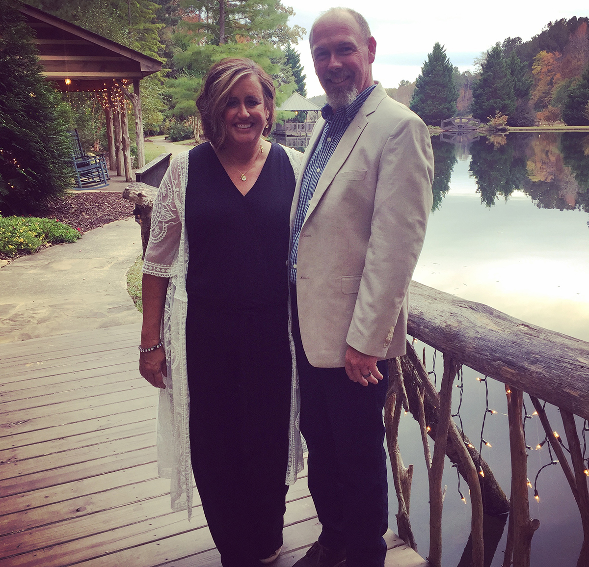 candi and her husband on a bridge