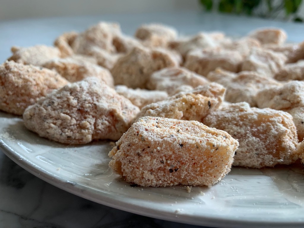 chicken bites with protein powder and seasoning on them