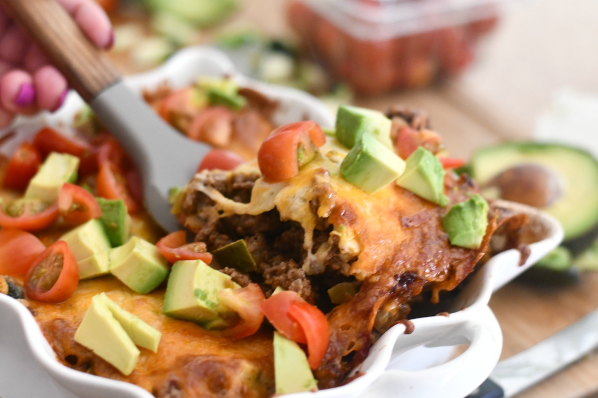 dishing up keto tex mex casserole from baking dish