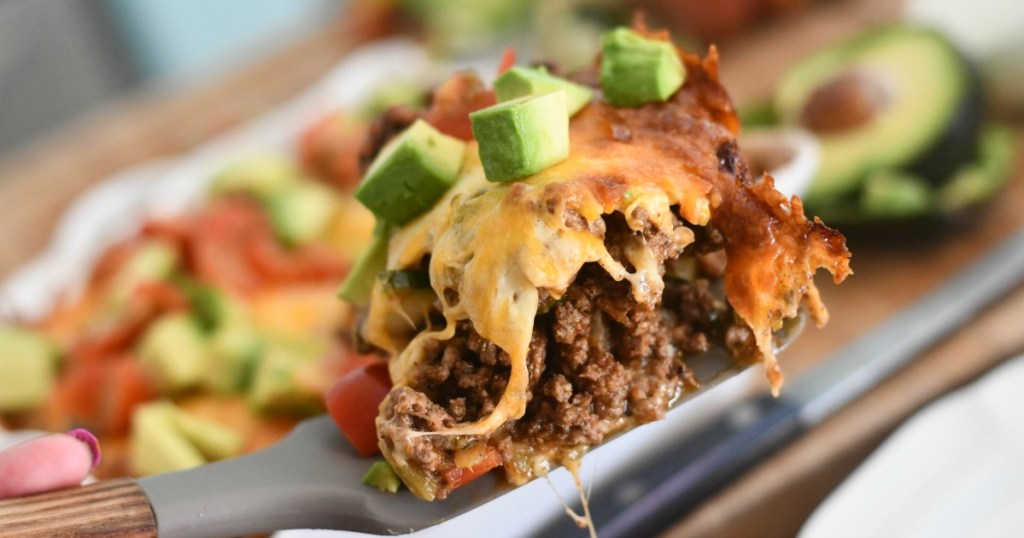 scooping keto tex mex casserole out of the casserole dish