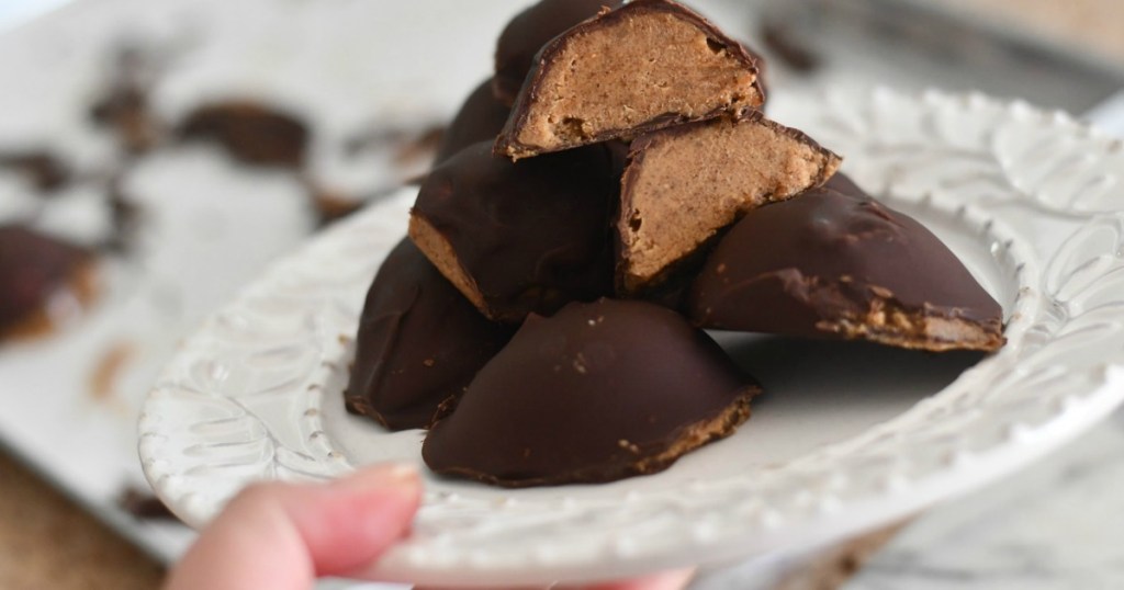 holding keto chocolate almond butter easter eggs on plate