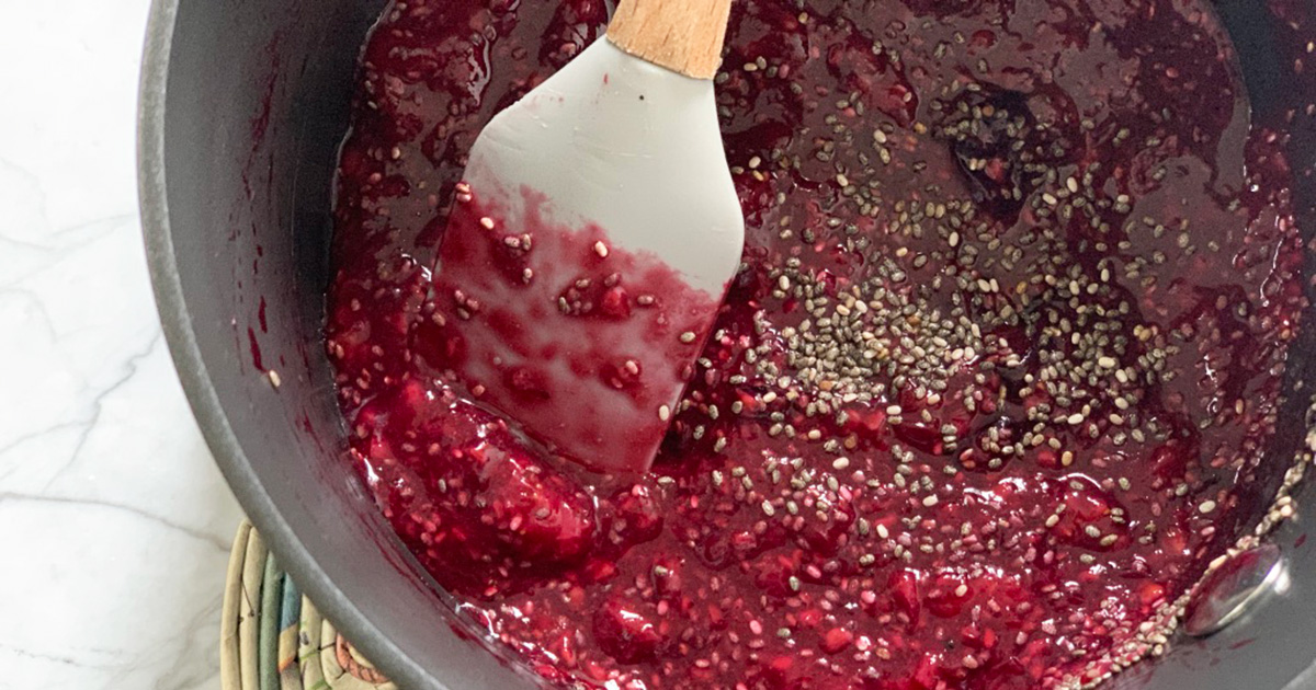 a small pot with crushed berries and chia seeds