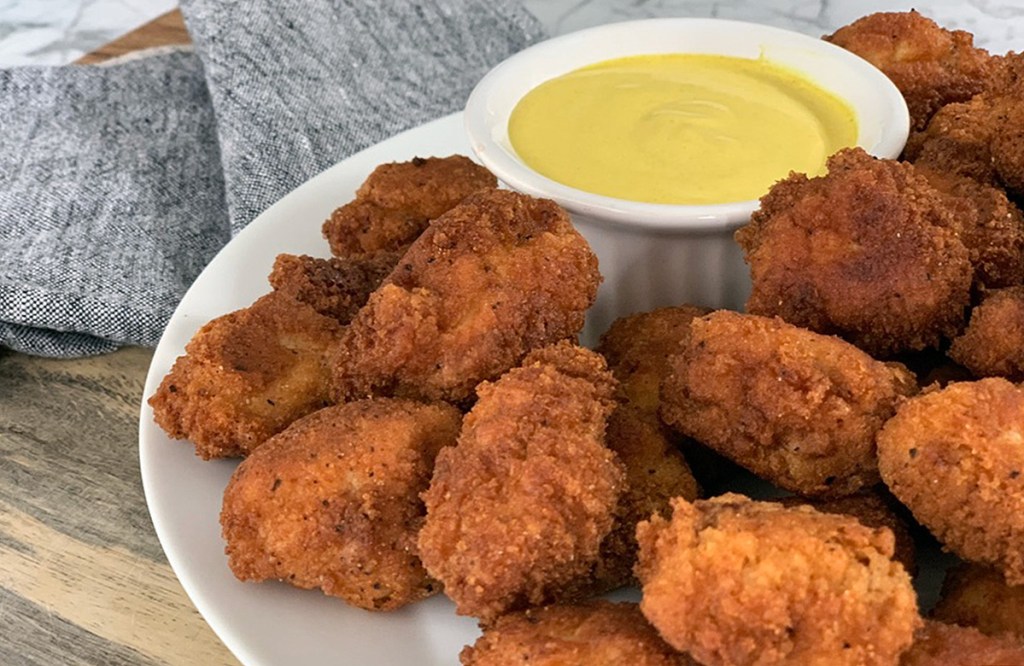pickle brined keto chicken nuggets on plate with honey mustard sauce