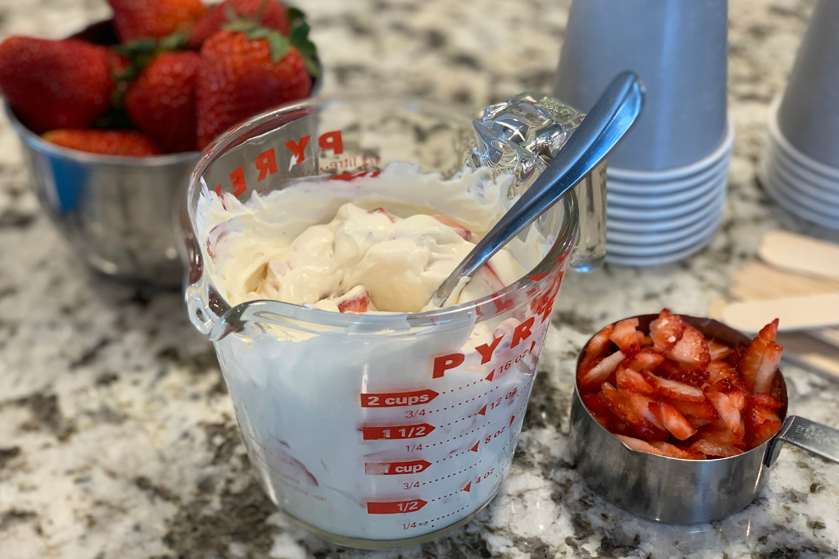 yummy strawberry cheesecake batter alongside fresh strawberries