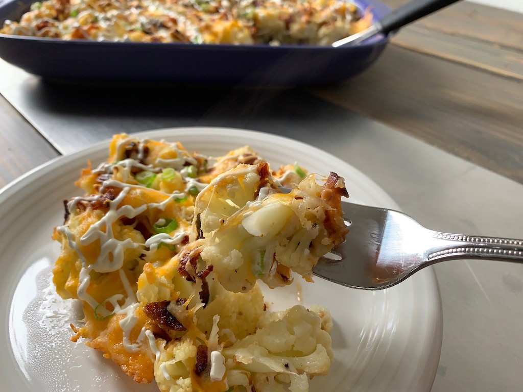 taking bite of keto loaded cauliflower casserole 