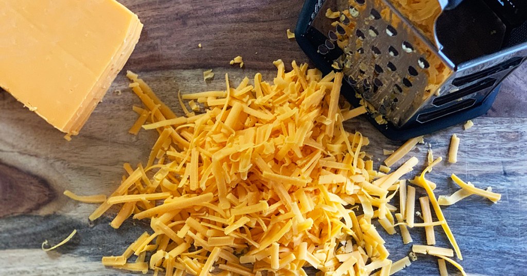 a pile of freshly shredded cheddar cheese