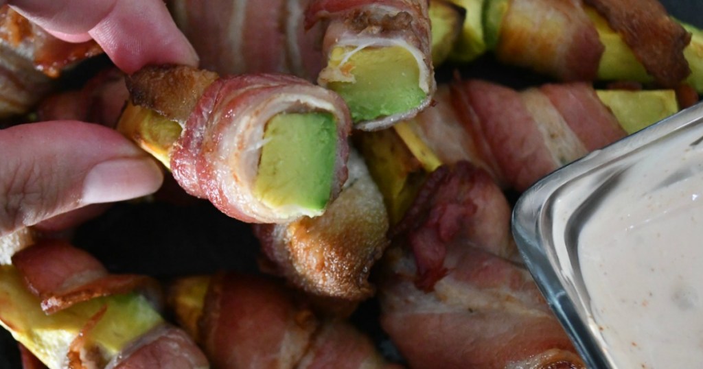 holding bacon wrapped avocado fries 