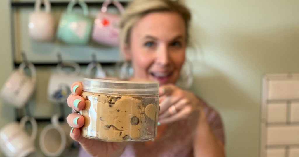 woman holding container of Bhu cookie dough