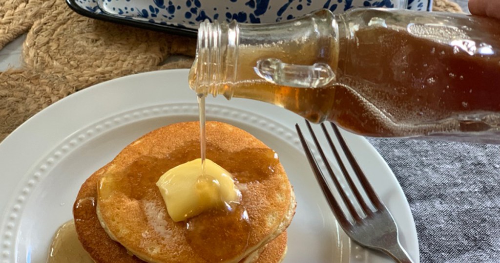yummy sugar-free syrup being poured onto keto pancakes