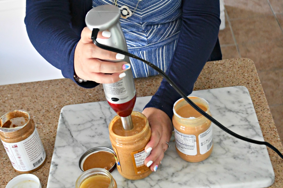 Lina using an immersion blender in a jar of peanut butter