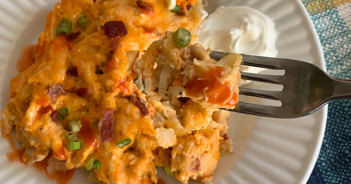 a forkful of Buffalo chicken casserole with Frank's hot sauce