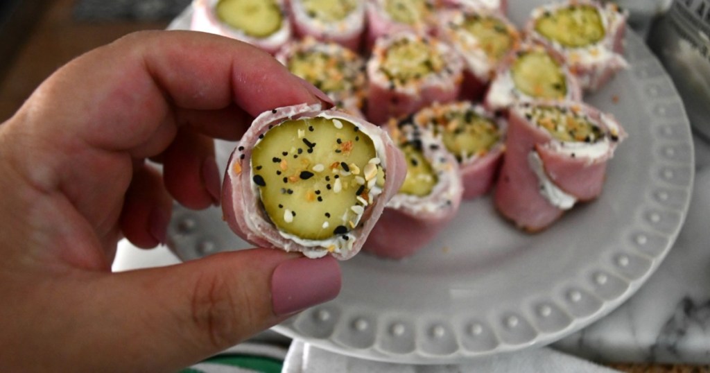 holding ham pickle and cream cheese roll-up