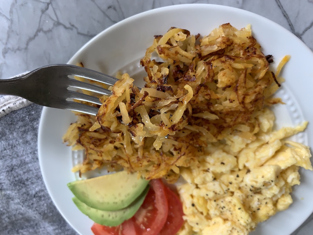 keto rutabaga hash browns with eggs and avocado on a plate