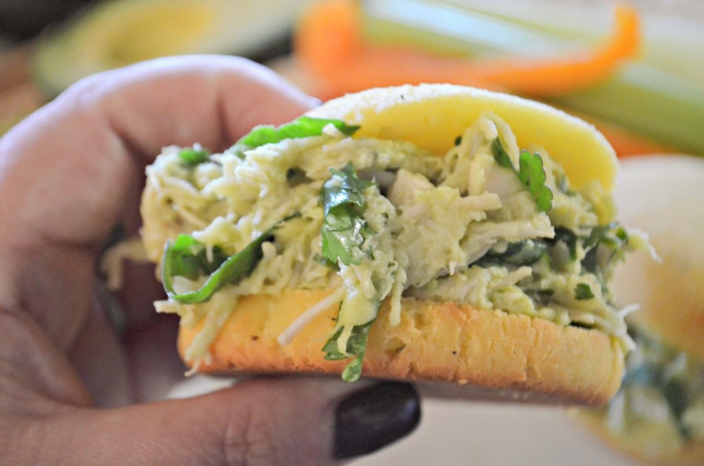 holding a keto avocado chicken salad sandwich