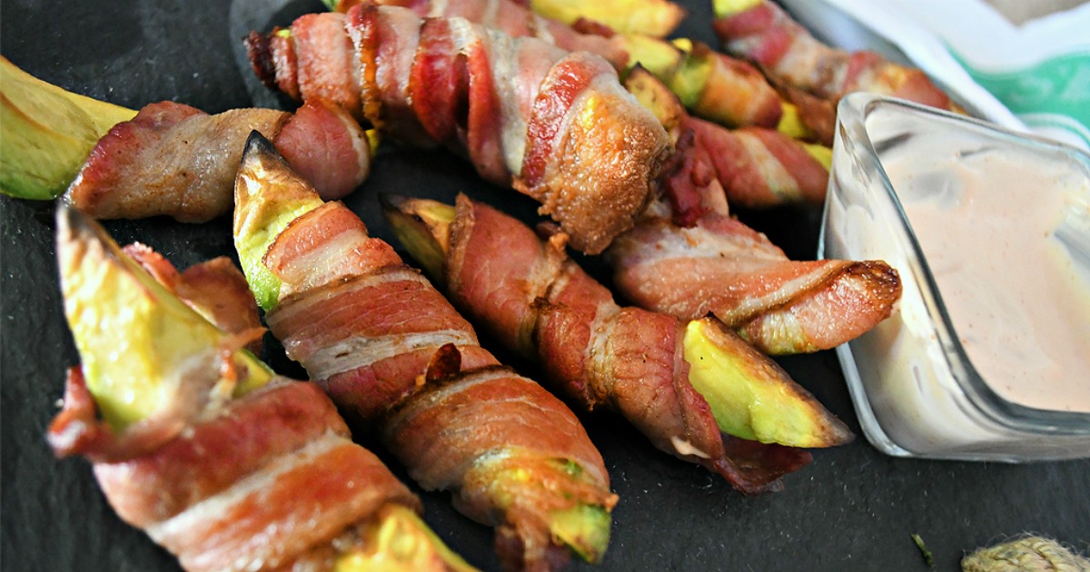 keto bacon wrapped fries on a plate with dipping sauce