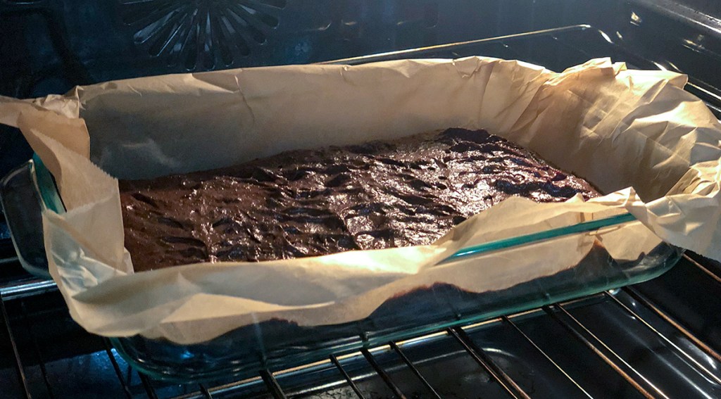 fudgy keto brownies — brownies in pan cooking in the oven