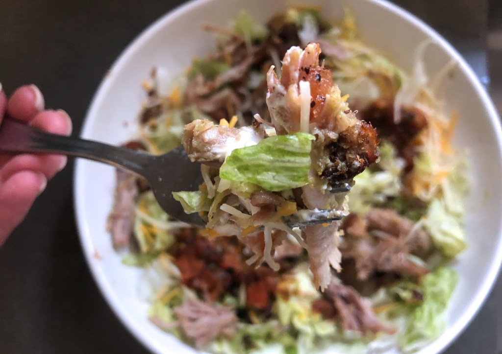 trader joe's carnitas recommendation — close up on forkful of carnitas salad