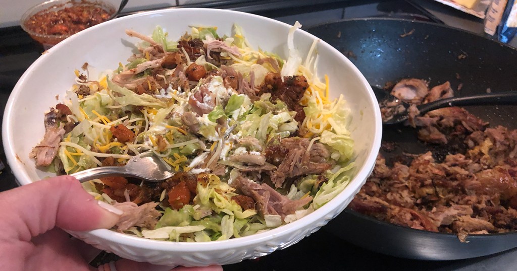 trader joe's carnitas recommendation — pork carnitas salad next to carnitas cooking in skillet