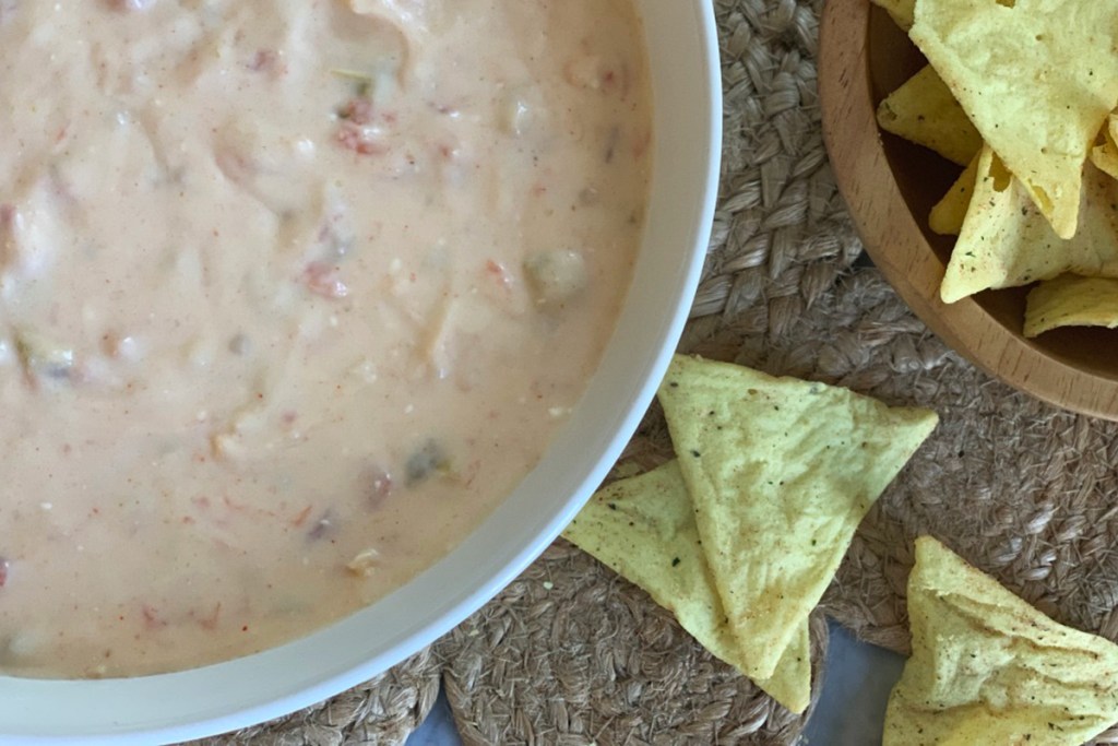 a bowl of cheesy Mexican queso dip served with Quest chips