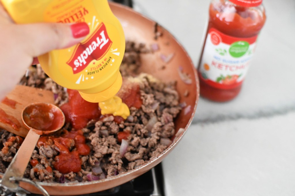 cooking ground beef with ketchup and mustard