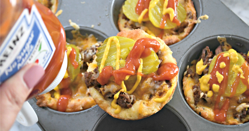 pouring ketchup on a keto cheeseburger muffin 