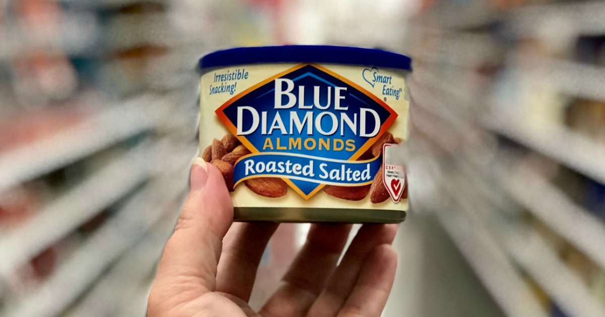 hand holding a small can of blue diamond almonds in store