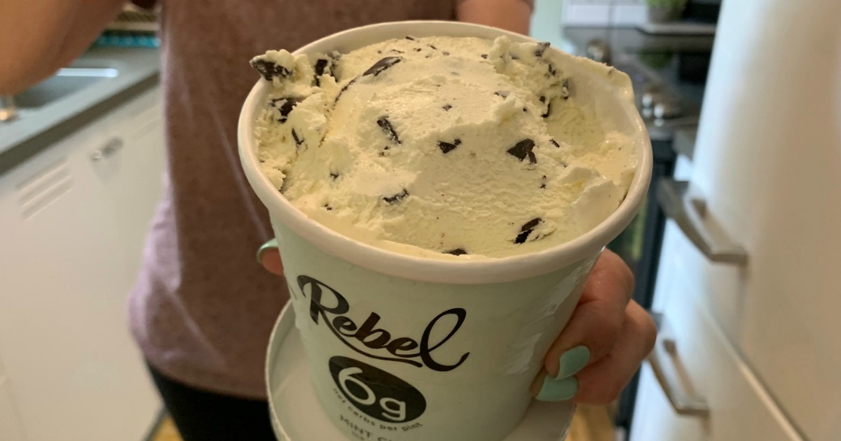 holding pint of rebel mint chocolate chip keto ice cream