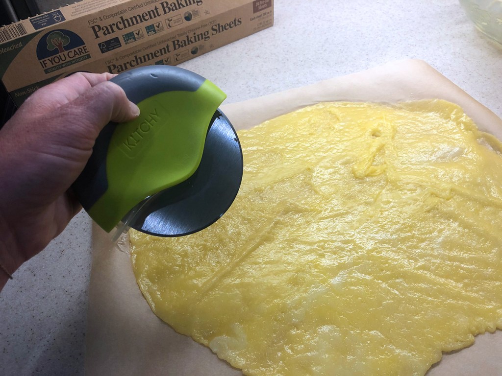 using pizza cutter to slice noodles