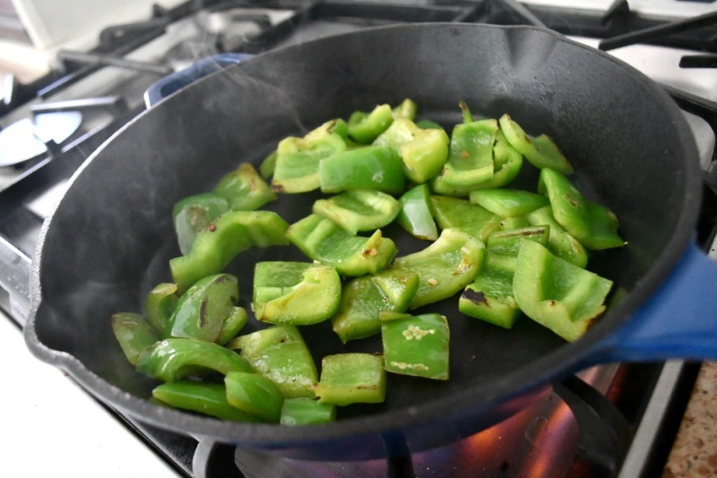 sauteed bell peppers in a cast iron skillet
