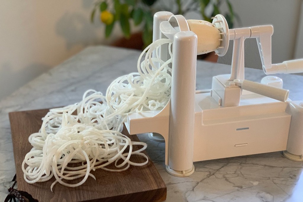 a daikon radish being spiralized