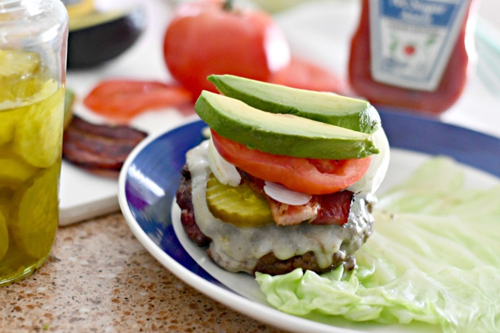 ultimate keto burger with cheese bacon avocado tomato and onion