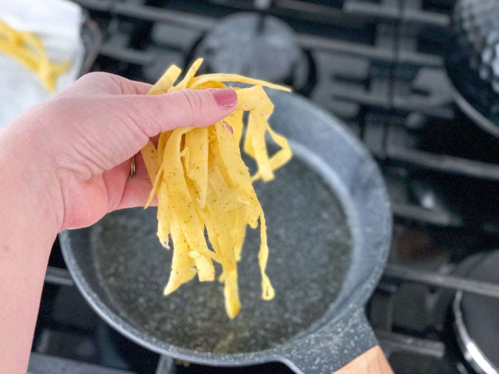 adding keto pasta to a skillet