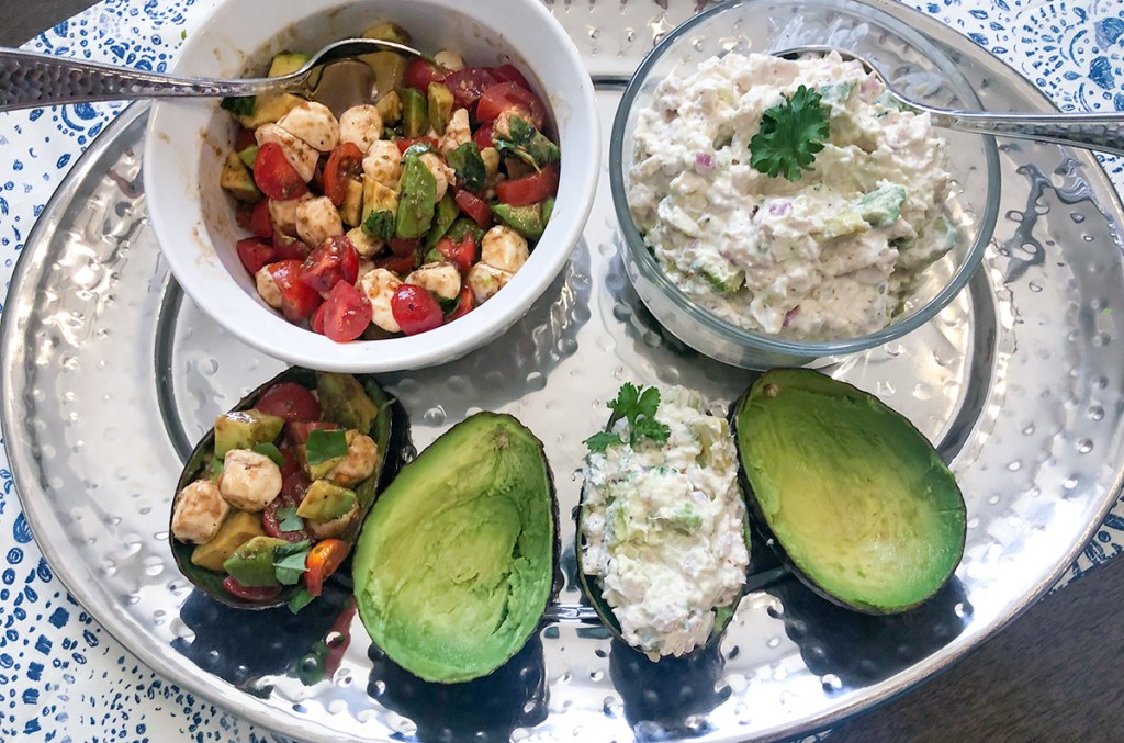 arrangement of caprese salad and chicken salad avocado boats