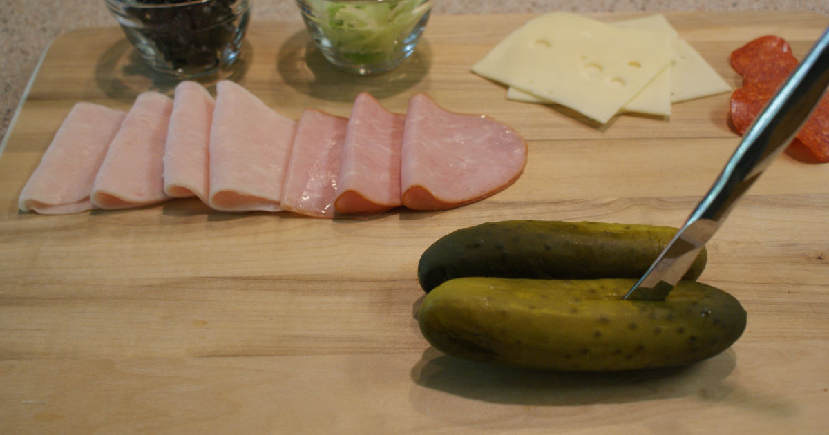 slicing the pickle in half lengthwise