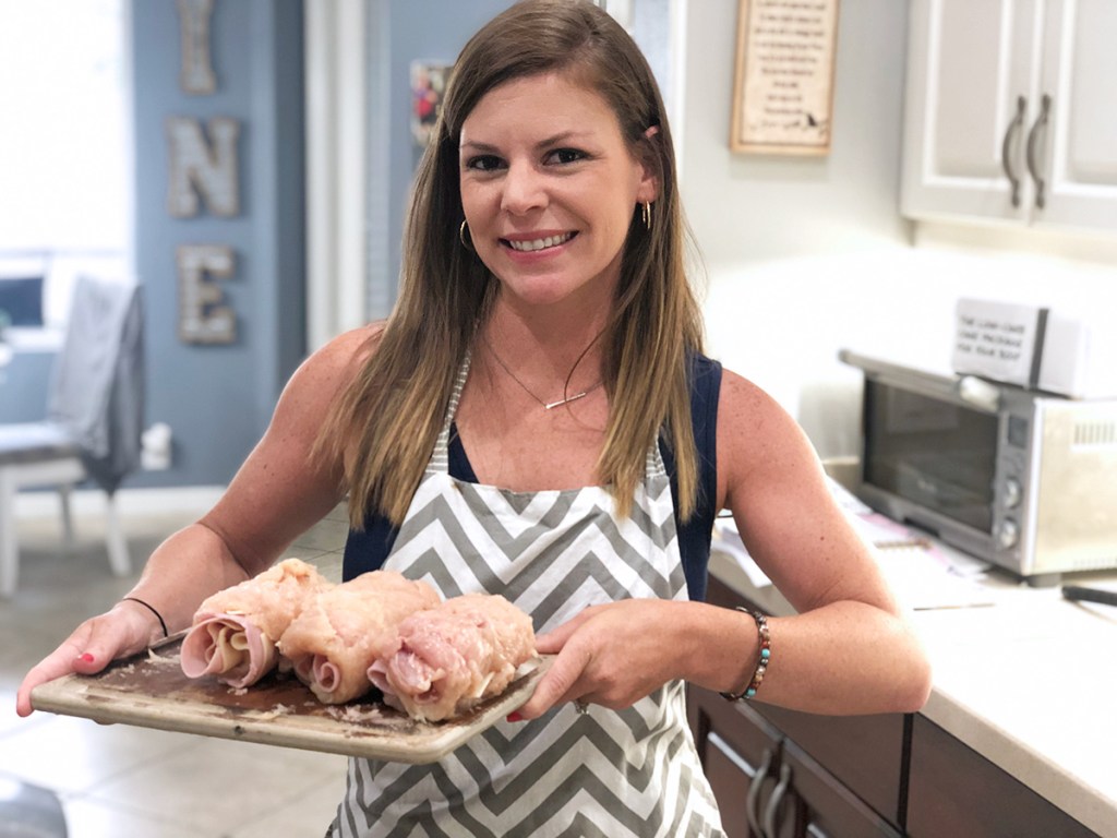 erica holding up a plate of chicken cordon bleu rolls