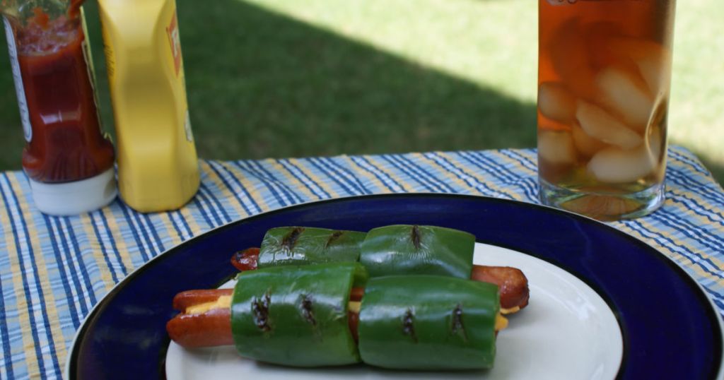 jalapeno stuffed hot dog with cheese on plate served ready to eat