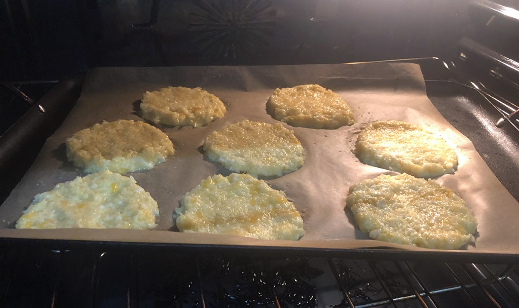 keto cauliflower english muffins on tray in the oven