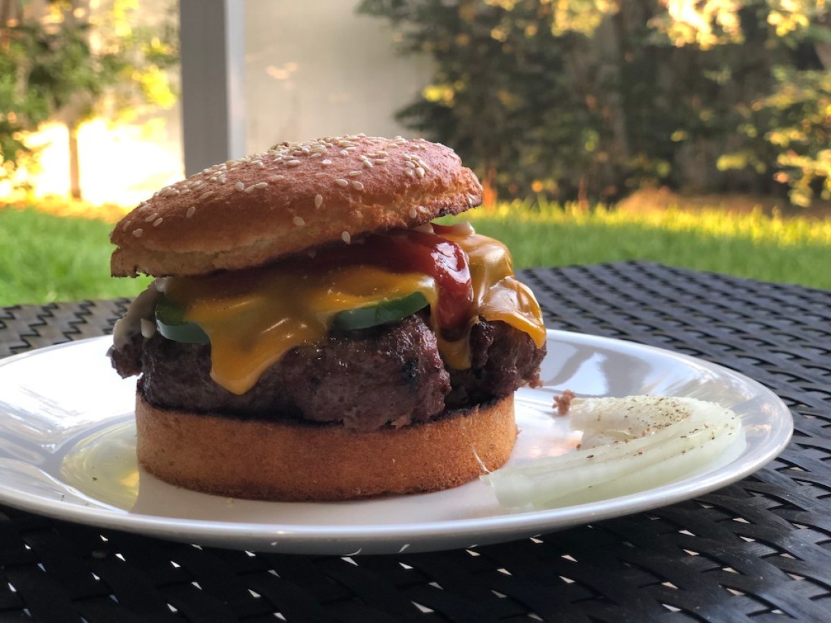 Smartbun keto hamburger bun with burger, cheese, jalapeno on plate 