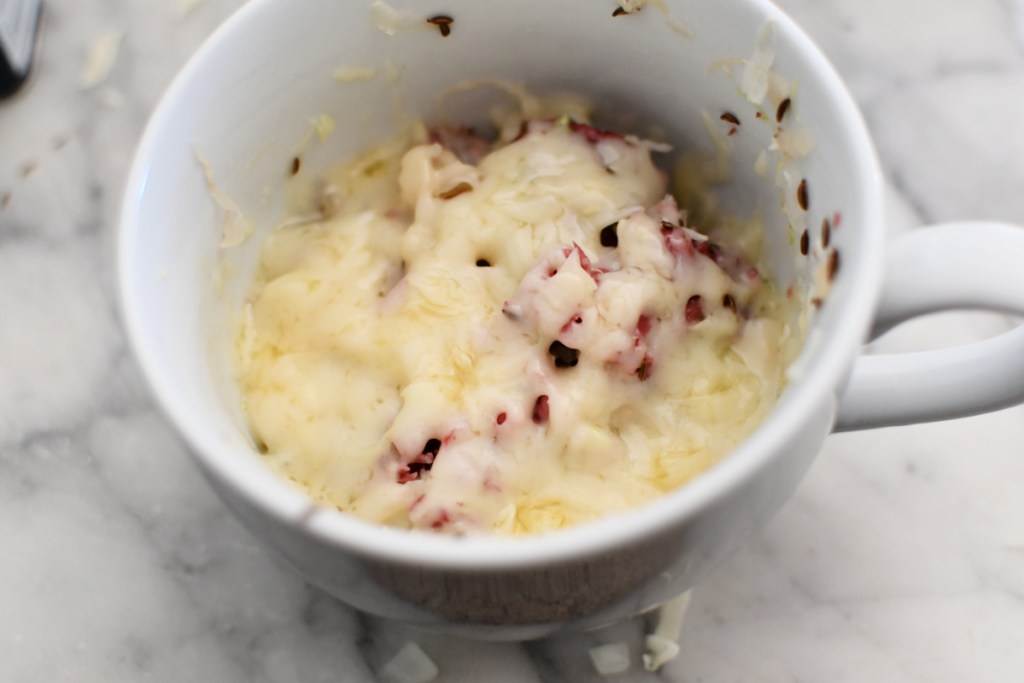 melting cheese on a keto reuben mug